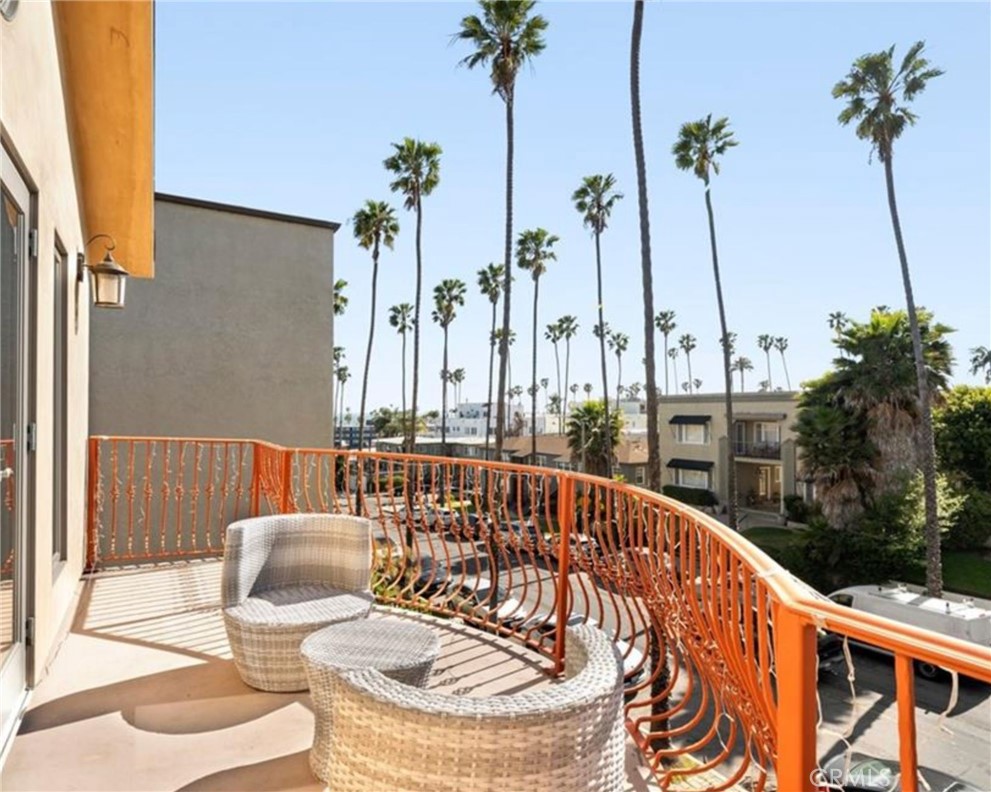 Primary balcony at 116 Termino overlooking palm-lined Belmont Heights streets